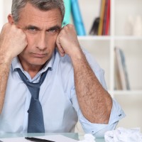 Fighting Writer’s Block uninspired writer amid paper balls